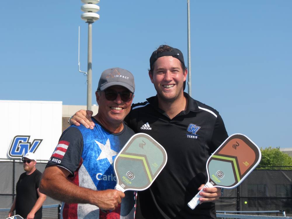 Two Lakers standing together with their pickleball paddles.